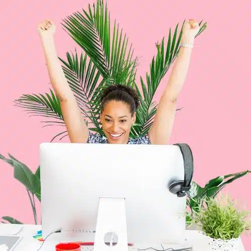 Joyful office employee relishing in a workspace abundant with plants