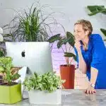 Image of Juliette, the founder of My City Plants surrounded by houseplants